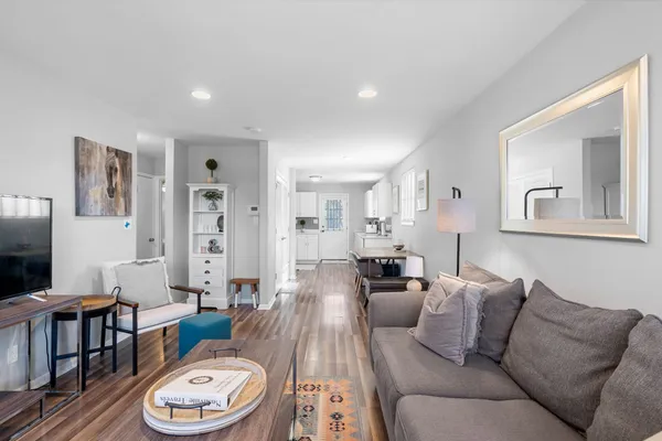 a living room with furniture a couch and a flat screen tv
