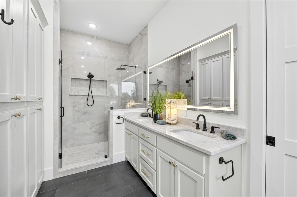 10373 Bobbie Lane Pilot Point, TX 76258 - Photo 19 of 40 Primary bathroom with walk in shower and separate tub. Dual dinks and ample cabinets for storage