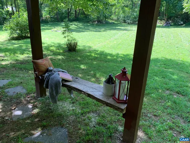 a backyard of a house with yard table and chairs