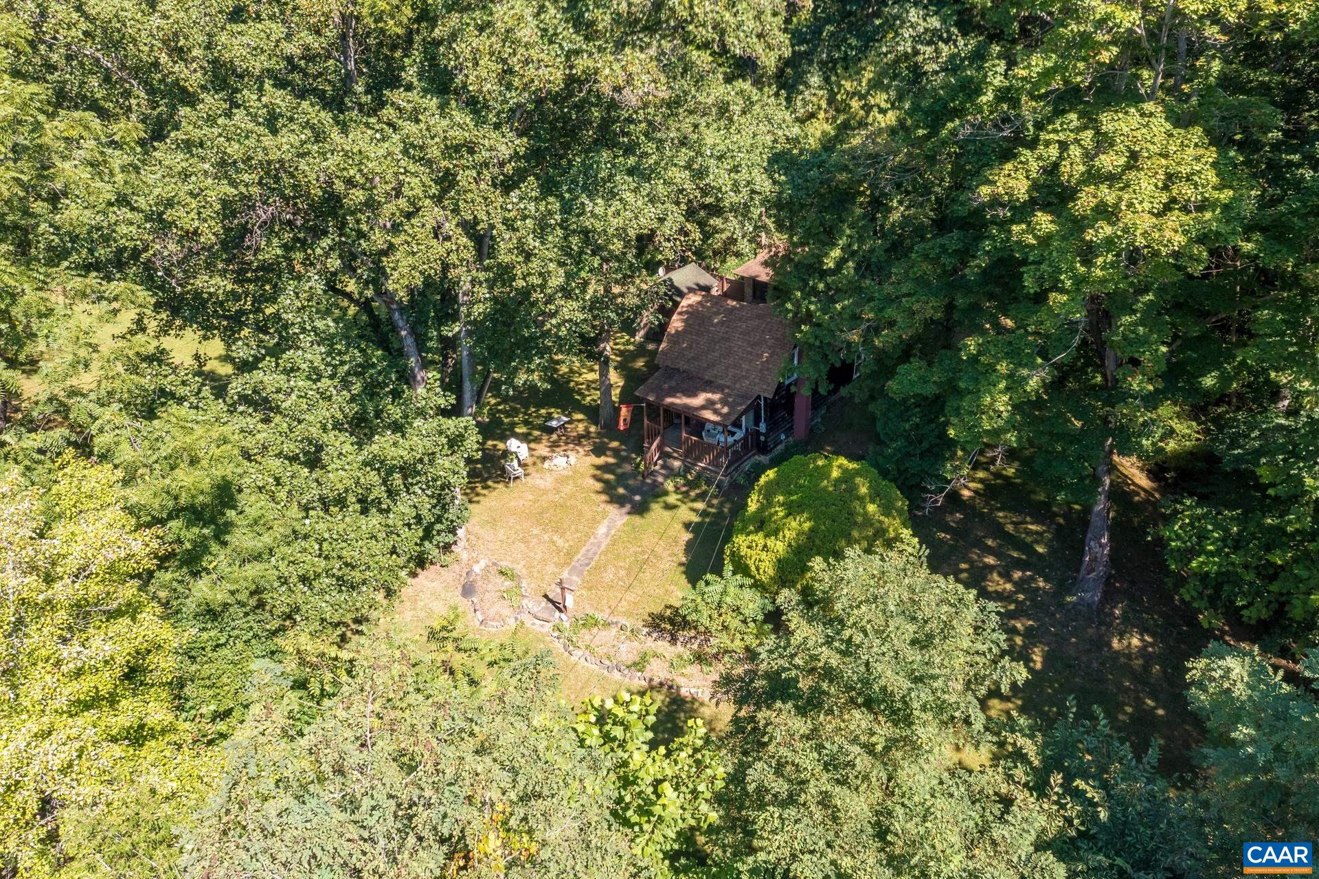 2960 Beech Grove Road Roseland, VA 22967 - Photo 20 of 73 a backyard of a house with a yard and fountain