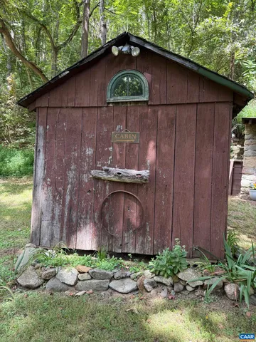a view of a hallway to a livingroom with furniture