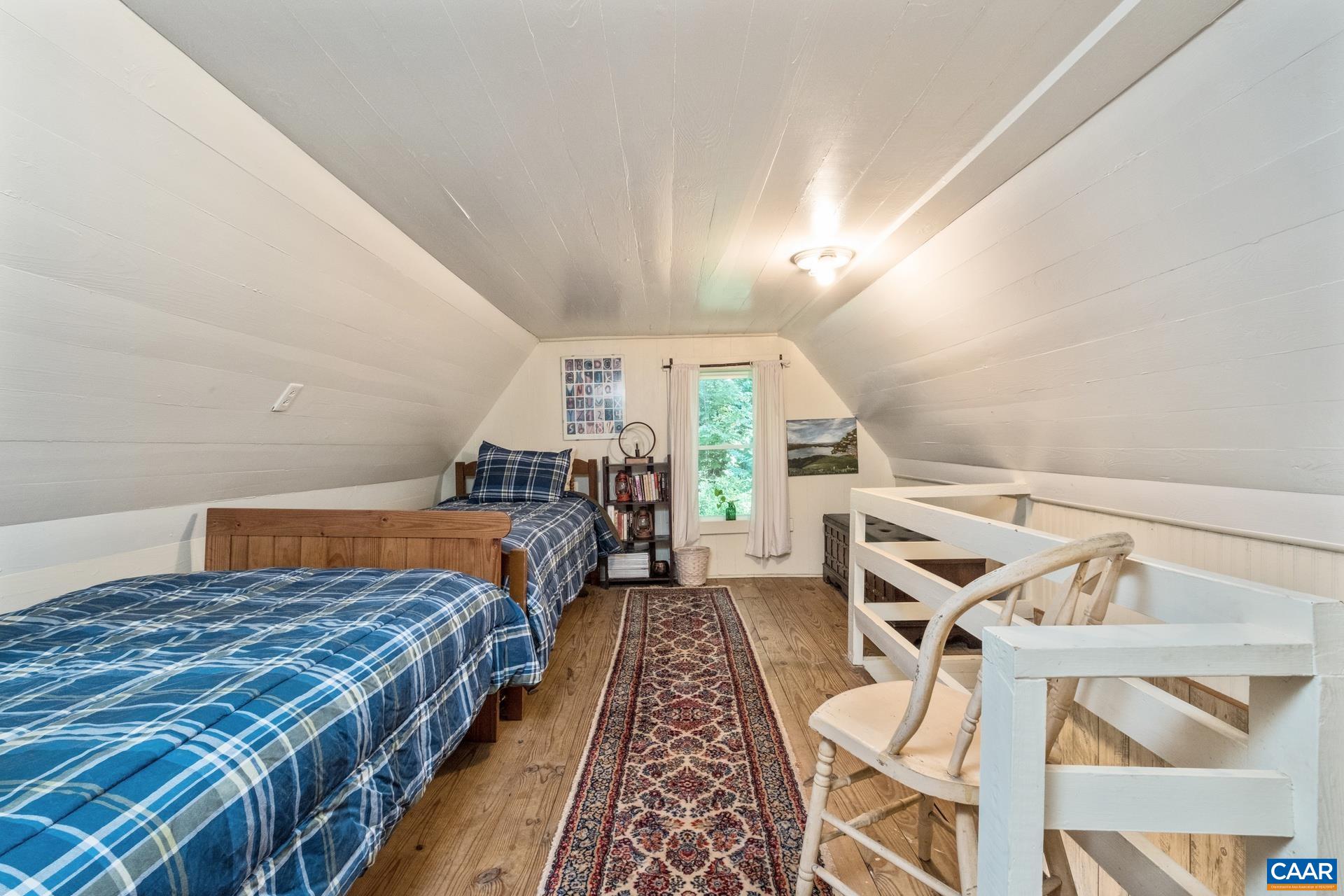 2960 Beech Grove Road Roseland, VA 22967 - Photo 40 of 73 a bed room with a bed and a chandelier