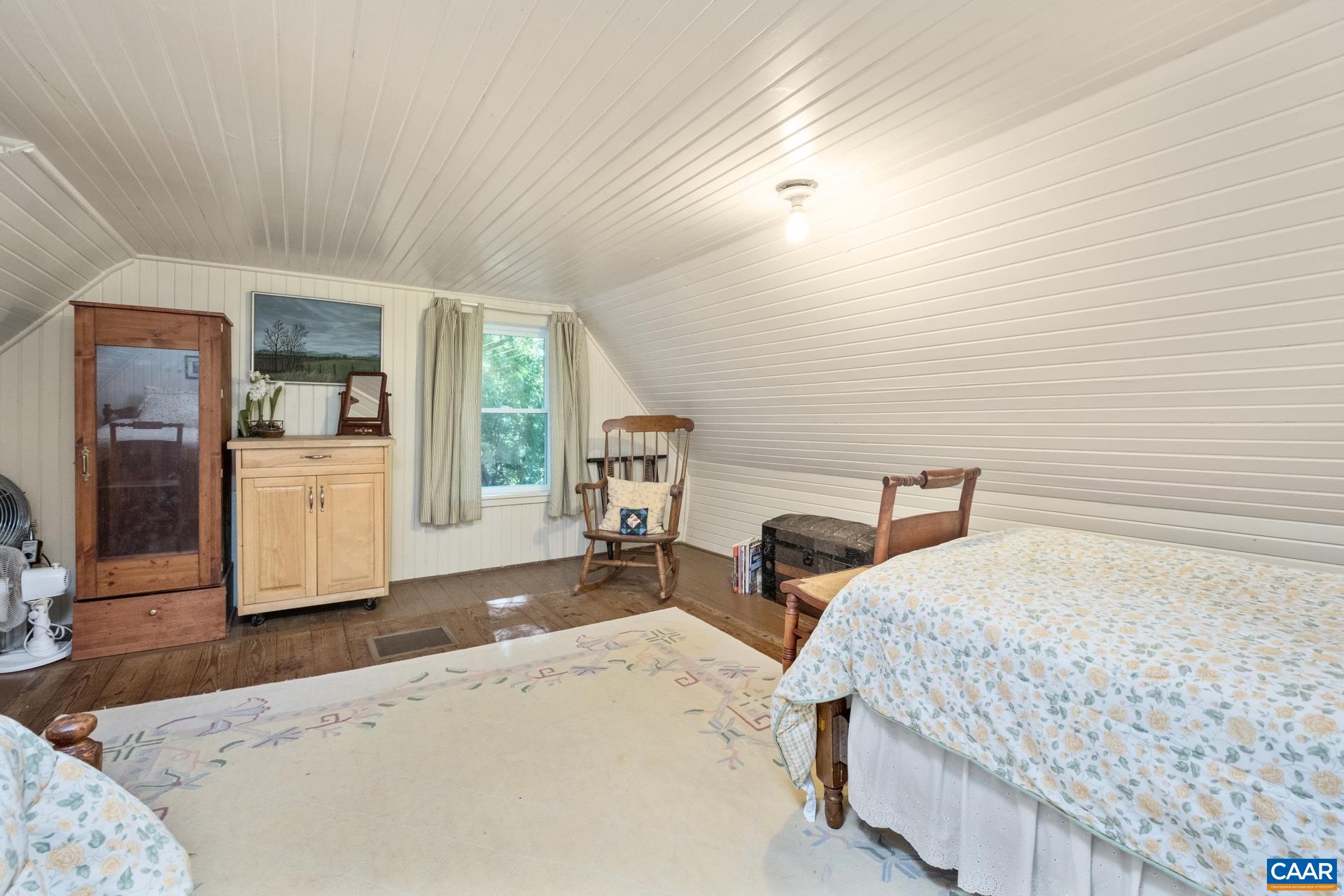 2960 Beech Grove Road Roseland, VA 22967 - Photo 44 of 73 a spacious bedroom with a bed a fireplace and windows