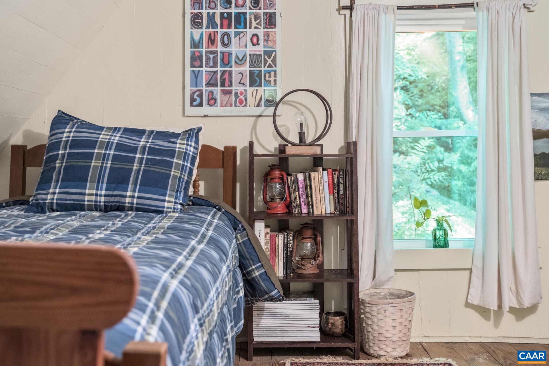2960 Beech Grove Road Roseland, VA 22967 - Photo 47 of 73 a bed sitting in a bedroom next to a window