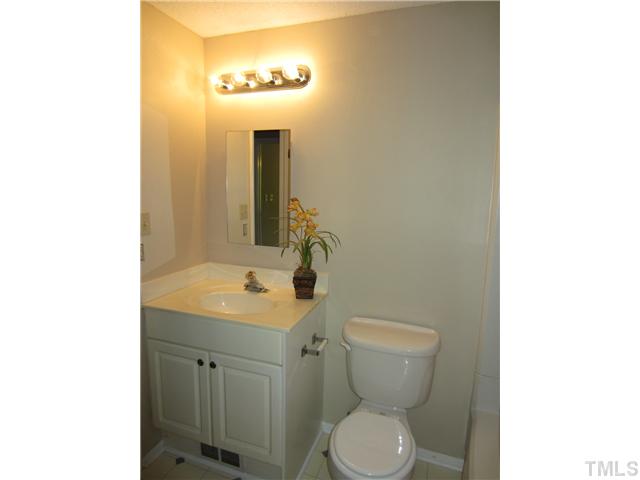 7704 Sandra Lane Raleigh, NC 27615 - Photo 13 of 17 a bathroom with a toilet sink and mirror
