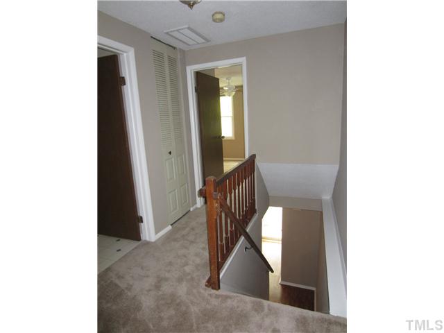 7704 Sandra Lane Raleigh, NC 27615 - Photo 14 of 17 a view of a hallway with wooden floor