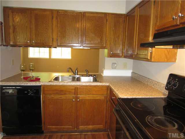 7704 Sandra Lane Raleigh, NC 27615 - Photo 4 of 17 a kitchen with a sink cabinets and window