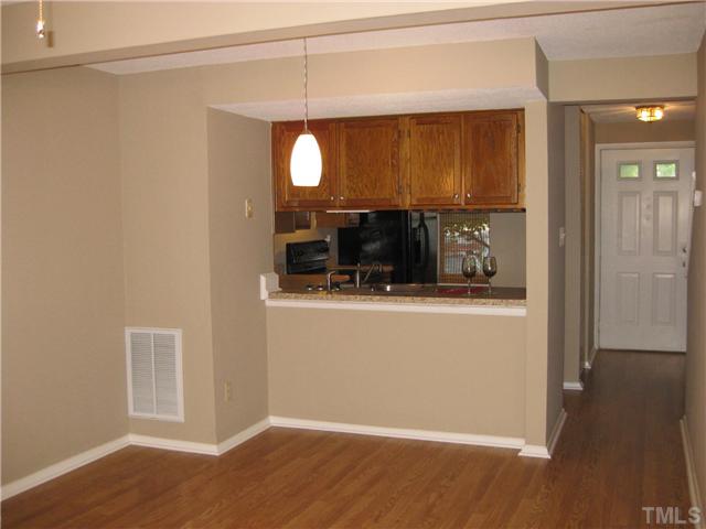 7704 Sandra Lane Raleigh, NC 27615 - Photo 6 of 17 an empty room with wooden floor mirror and entrance