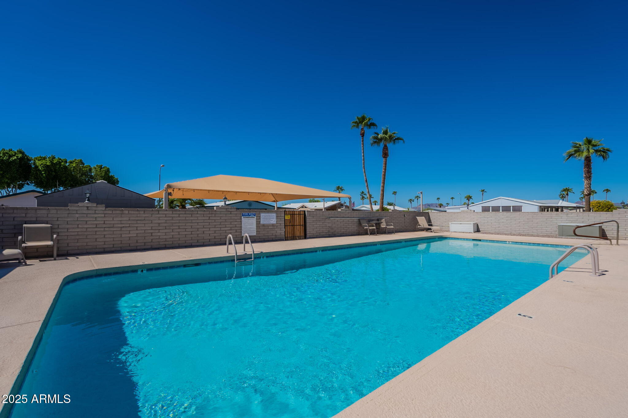 3700 South Tomahawk Road, Unit 39 Apache Junction, AZ 85119 - Photo 42 of 53 a view of a backyard with a tub and table
