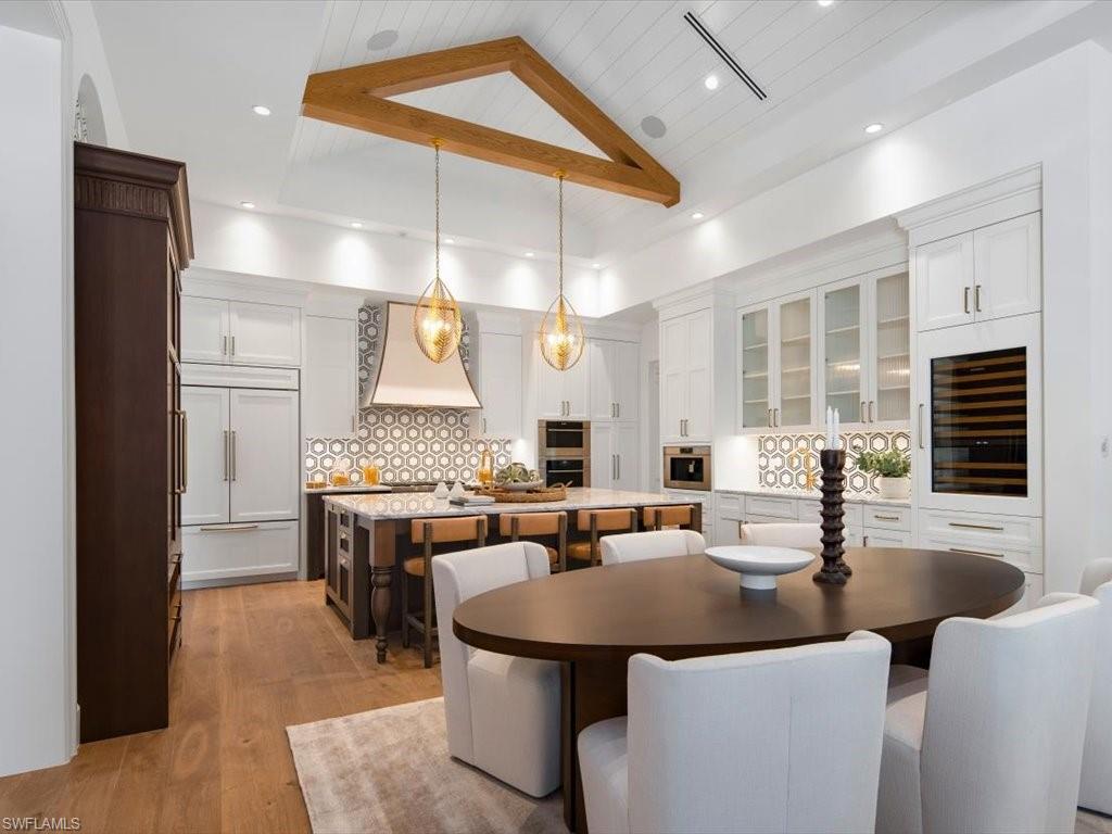 620 Binnacle Drive Naples, FL 34103 - Photo 14 of 49 Dining room with beverage cooler, wooden ceiling, high vaulted ceiling, and light hardwood / wood-style flooring
