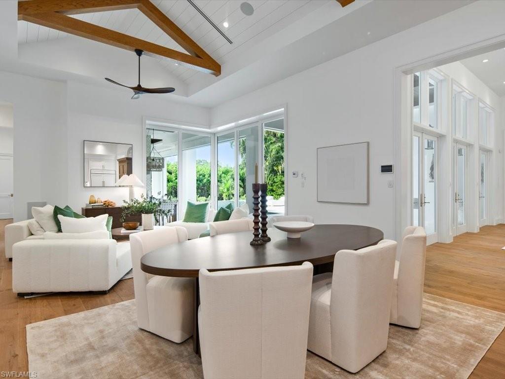 620 Binnacle Drive Naples, FL 34103 - Photo 16 of 49 Dining space featuring beamed ceiling, light wood-type flooring, ceiling fan, wood ceiling, and high vaulted ceiling