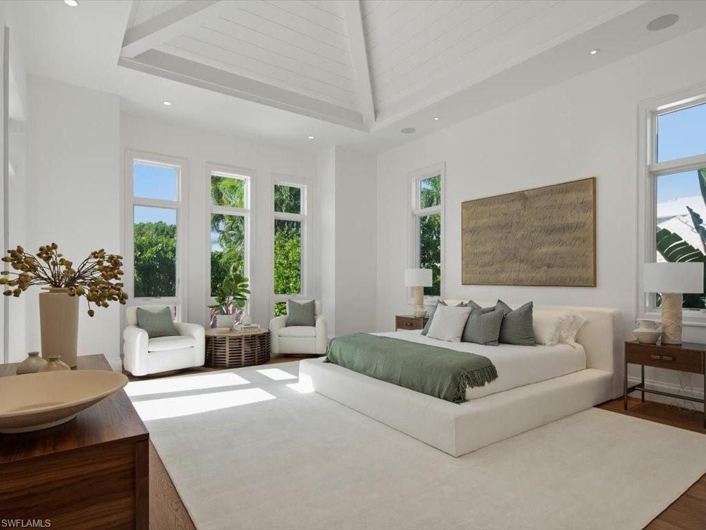 620 Binnacle Drive Naples, FL 34103 - Photo 20 of 49 Bedroom with wood-type flooring and high vaulted ceiling