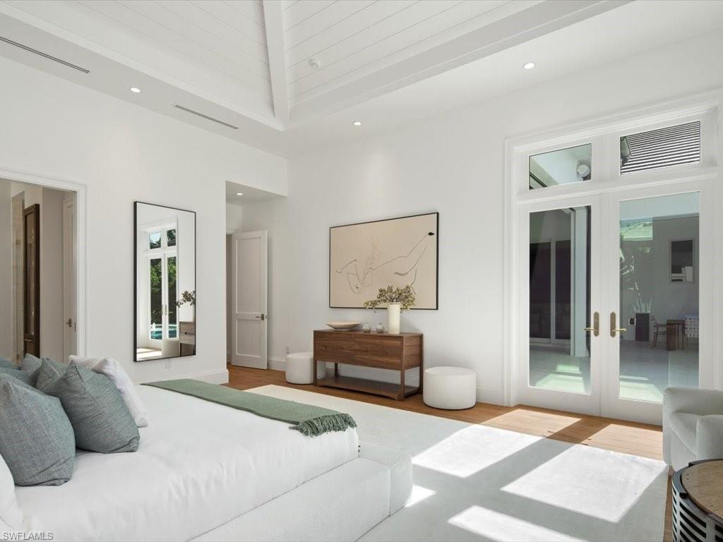 620 Binnacle Drive Naples, FL 34103 - Photo 22 of 49 Bedroom with high vaulted ceiling, french doors, light hardwood / wood-style floors, and access to outside