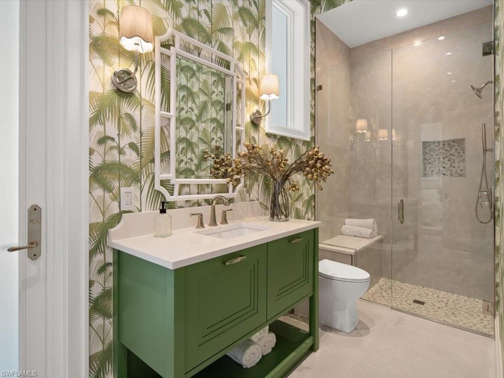 620 Binnacle Drive Naples, FL 34103 - Photo 29 of 49 Bathroom featuring an enclosed shower, vanity, and toilet