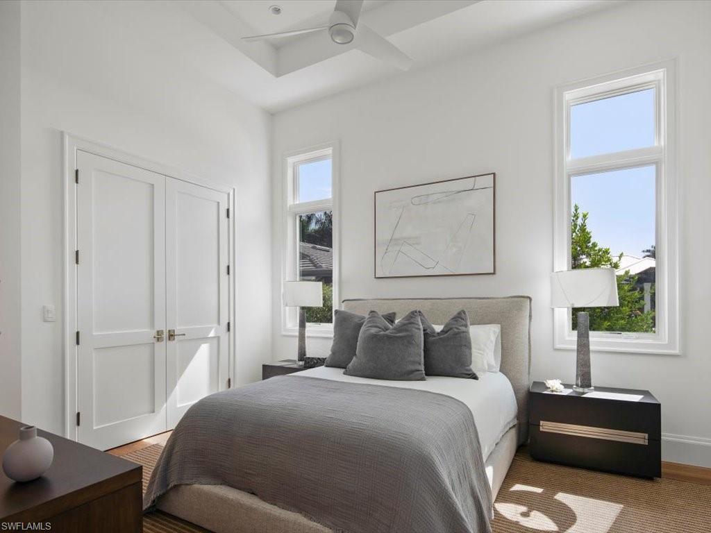 620 Binnacle Drive Naples, FL 34103 - Photo 31 of 49 Bedroom with multiple windows, ceiling fan, and hardwood / wood-style floors