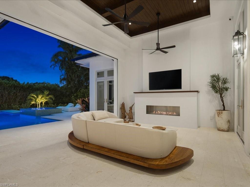 620 Binnacle Drive Naples, FL 34103 - Photo 35 of 49 Living room featuring a fireplace, wood ceiling, a high ceiling, and ceiling fan