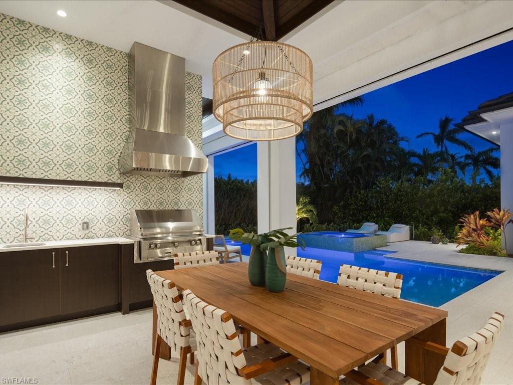 620 Binnacle Drive Naples, FL 34103 - Photo 37 of 49 Dining room featuring an inviting chandelier and sink