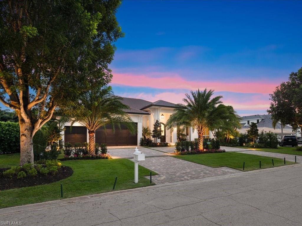 620 Binnacle Drive Naples, FL 34103 - Photo 45 of 49 View of front of property featuring a garage and a yard