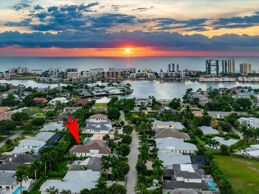 620 Binnacle Drive Naples, FL 34103 - Photo 48 of 49 Aerial view at dusk featuring a water view