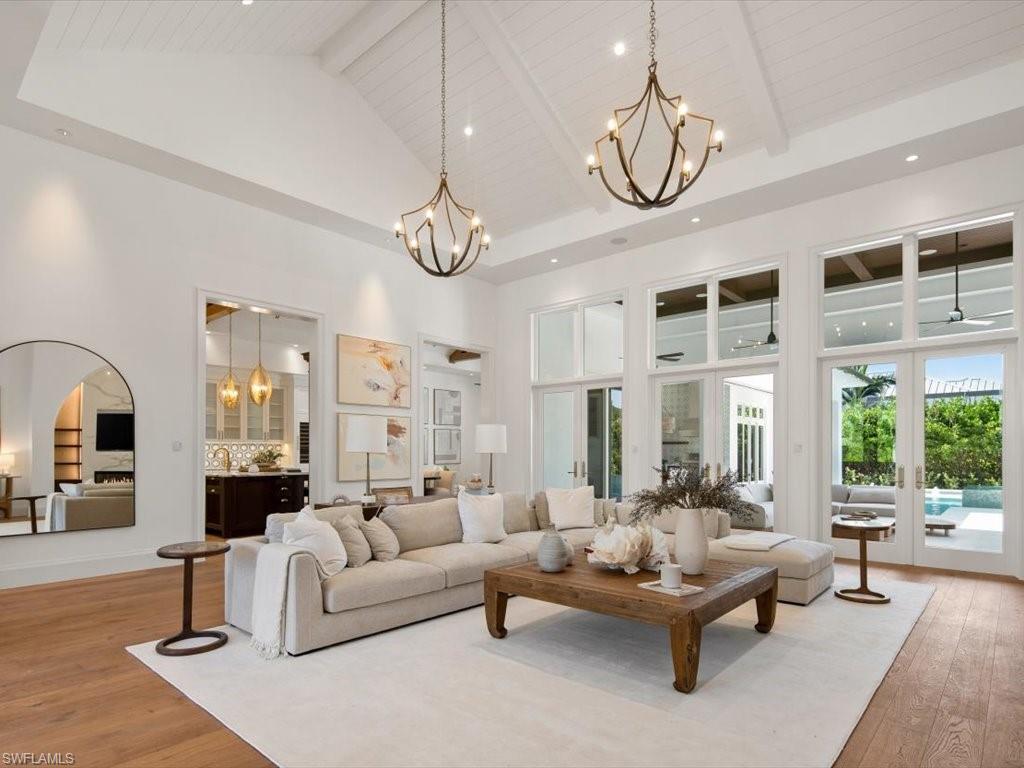 620 Binnacle Drive Naples, FL 34103 - Photo 5 of 49 Living room with beamed ceiling, a chandelier, high vaulted ceiling, hardwood / wood-style flooring, and wooden ceiling