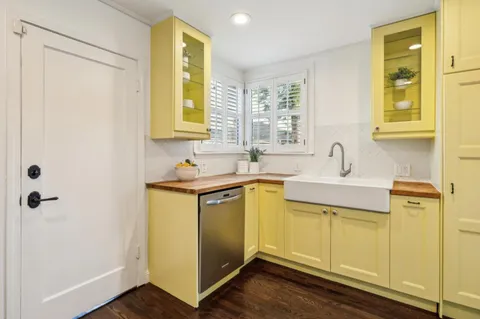 a bathroom with a sink mirror vanity and toilet