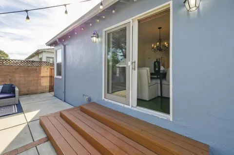 a view of a house with backyard and sitting area