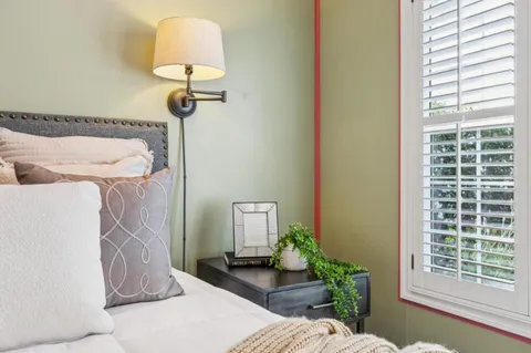 a bedroom with furniture and a window