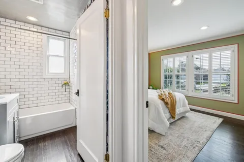 a view of a house with backyard and a tree