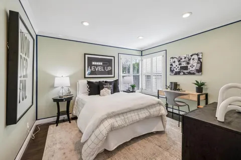 an aerial view of a residential houses with yard