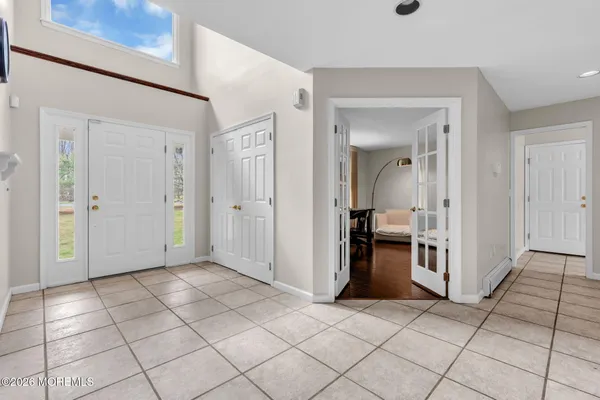 a view of a livingroom with a dinning table and entryway in a house