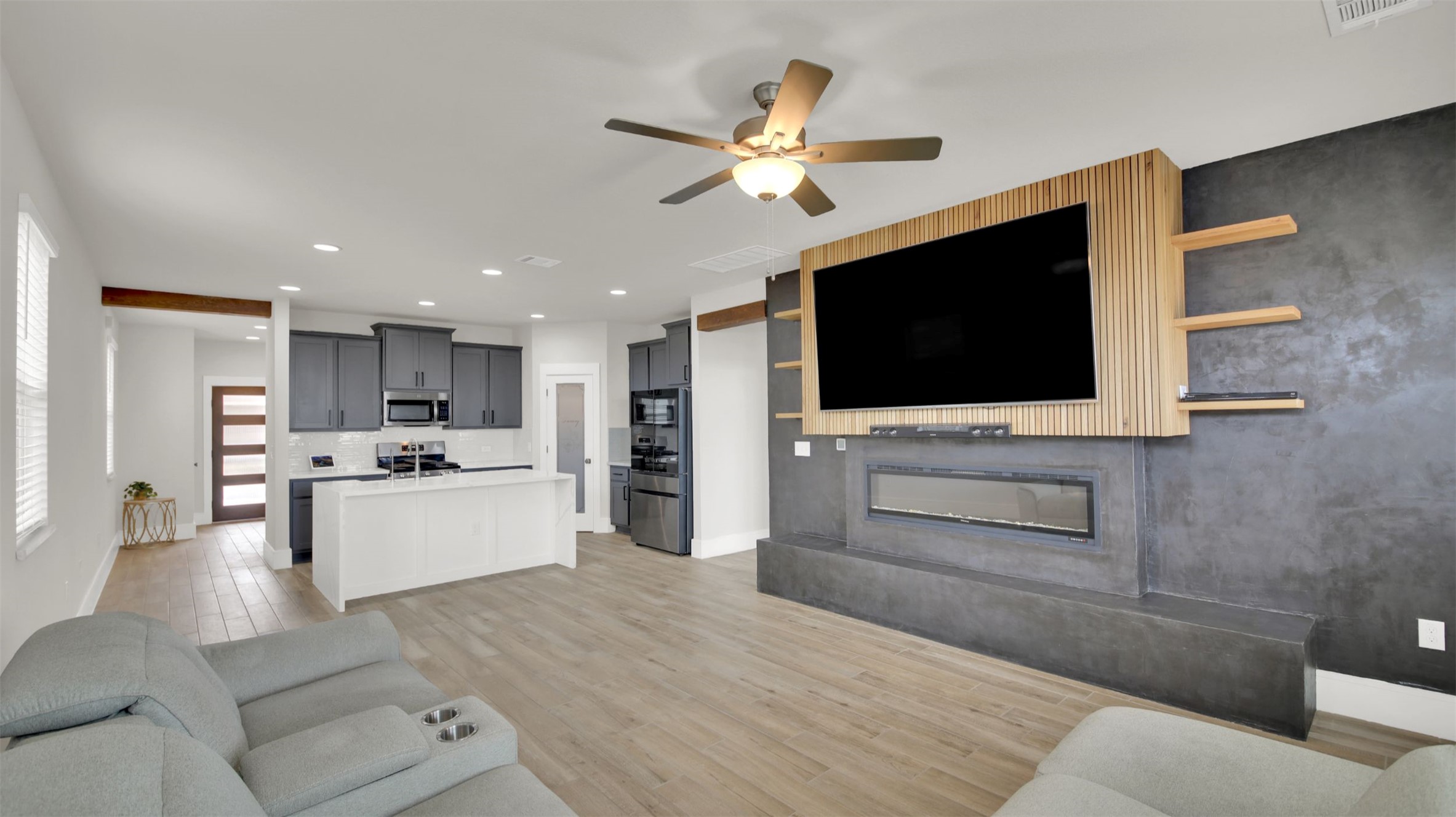 964 Pepperbark Loop Buda, TX 78610 - Photo 12 of 35 Living room with light wood-style flooring, recessed lighting, a ceiling fan, and a premium fireplace