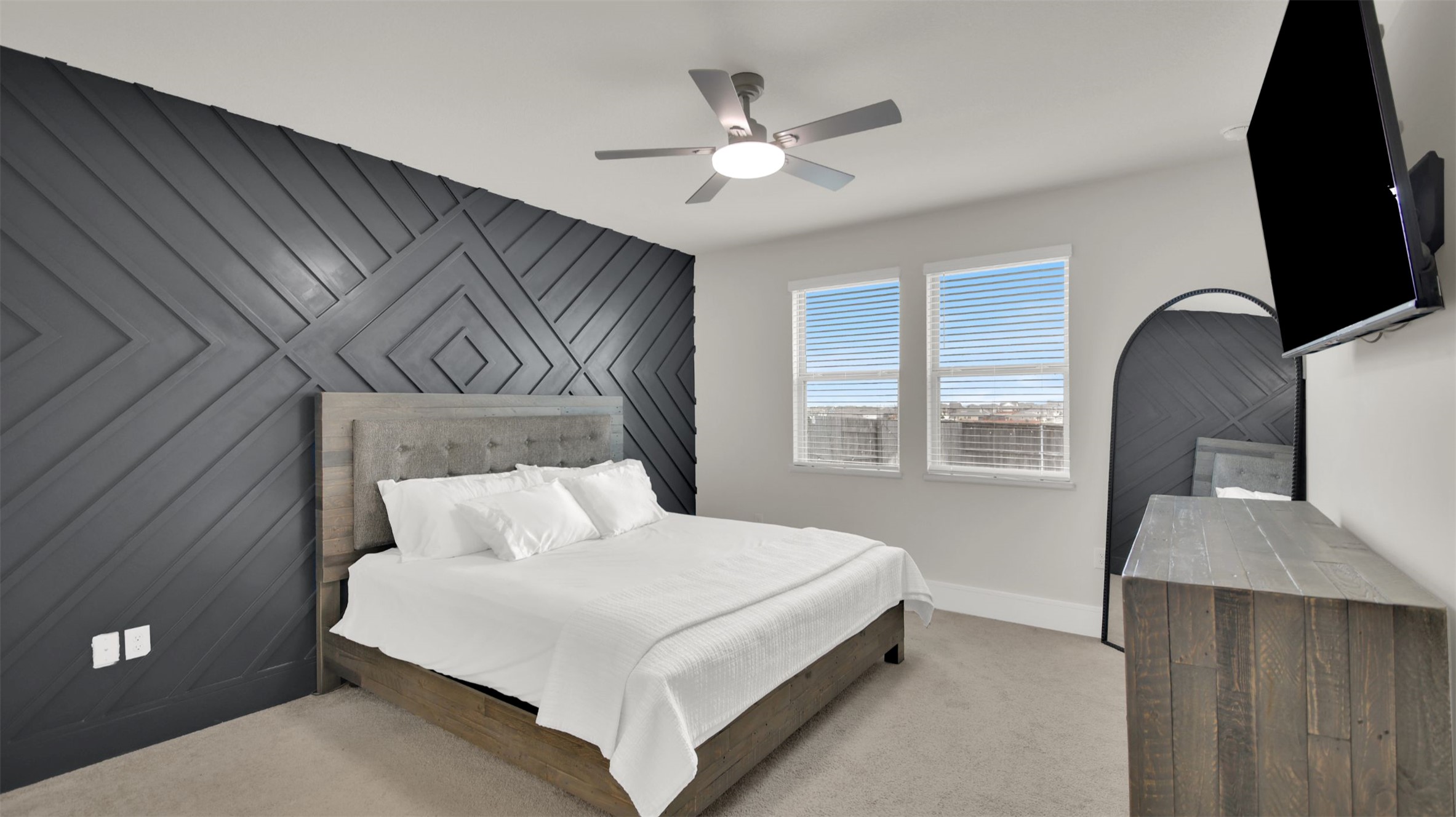 964 Pepperbark Loop Buda, TX 78610 - Photo 15 of 35 Carpeted bedroom with an accent wall, wood walls, and a ceiling fan