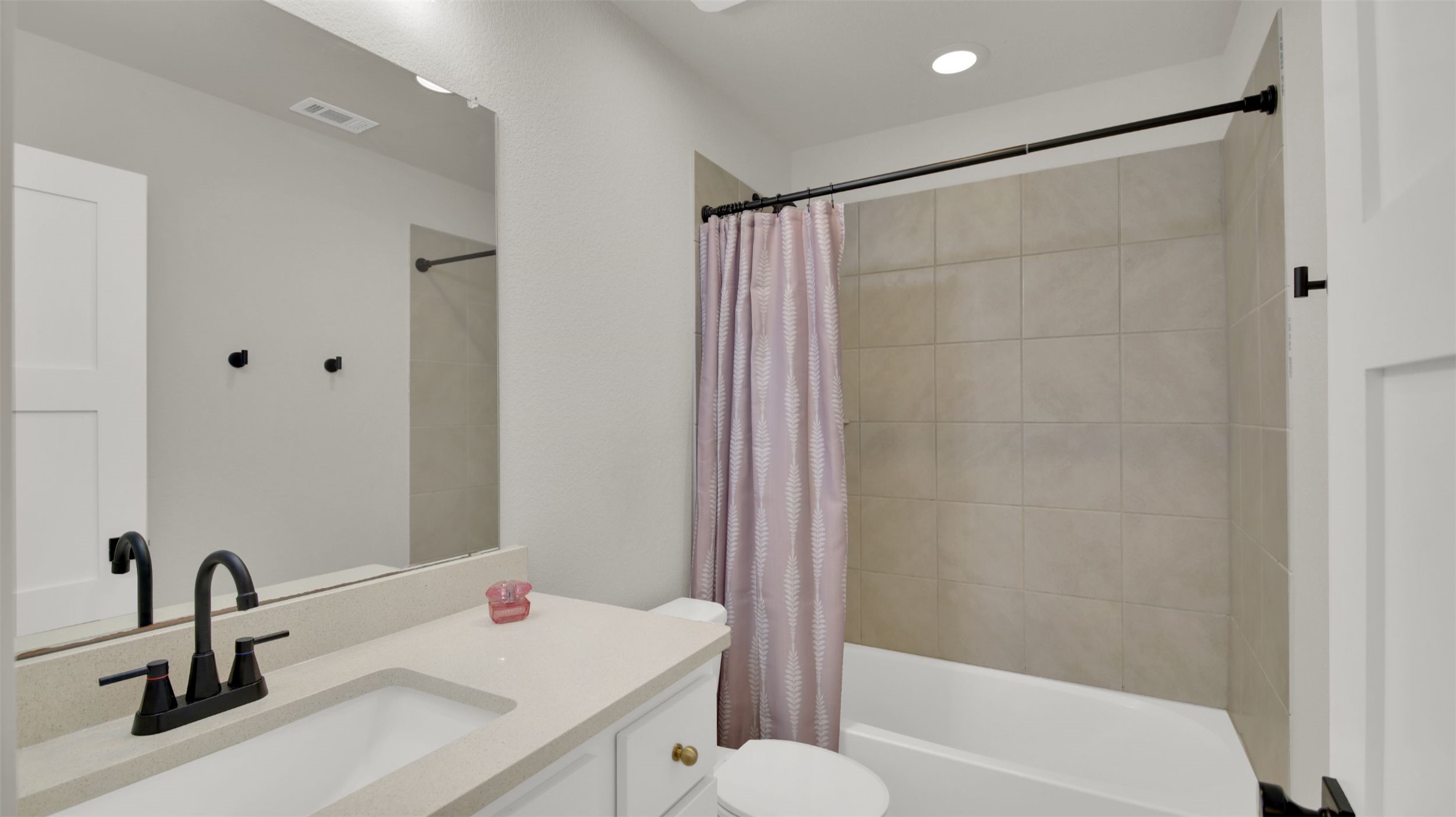 964 Pepperbark Loop Buda, TX 78610 - Photo 16 of 23 Bathroom with vanity, shower / bath combination with curtain, and recessed lighting