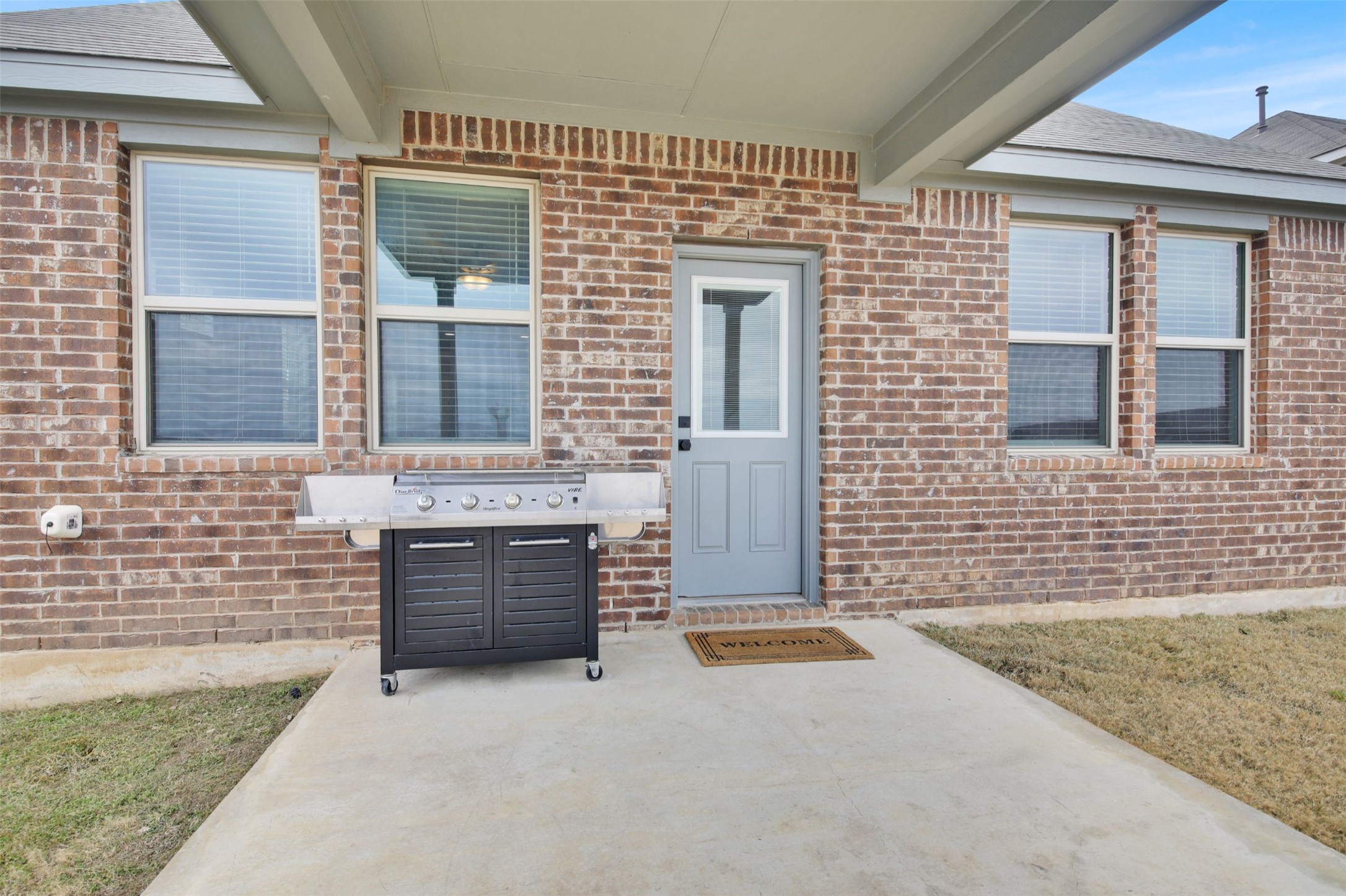 964 Pepperbark Loop Buda, TX 78610 - Photo 28 of 35 View of exterior entry featuring brick siding and a patio