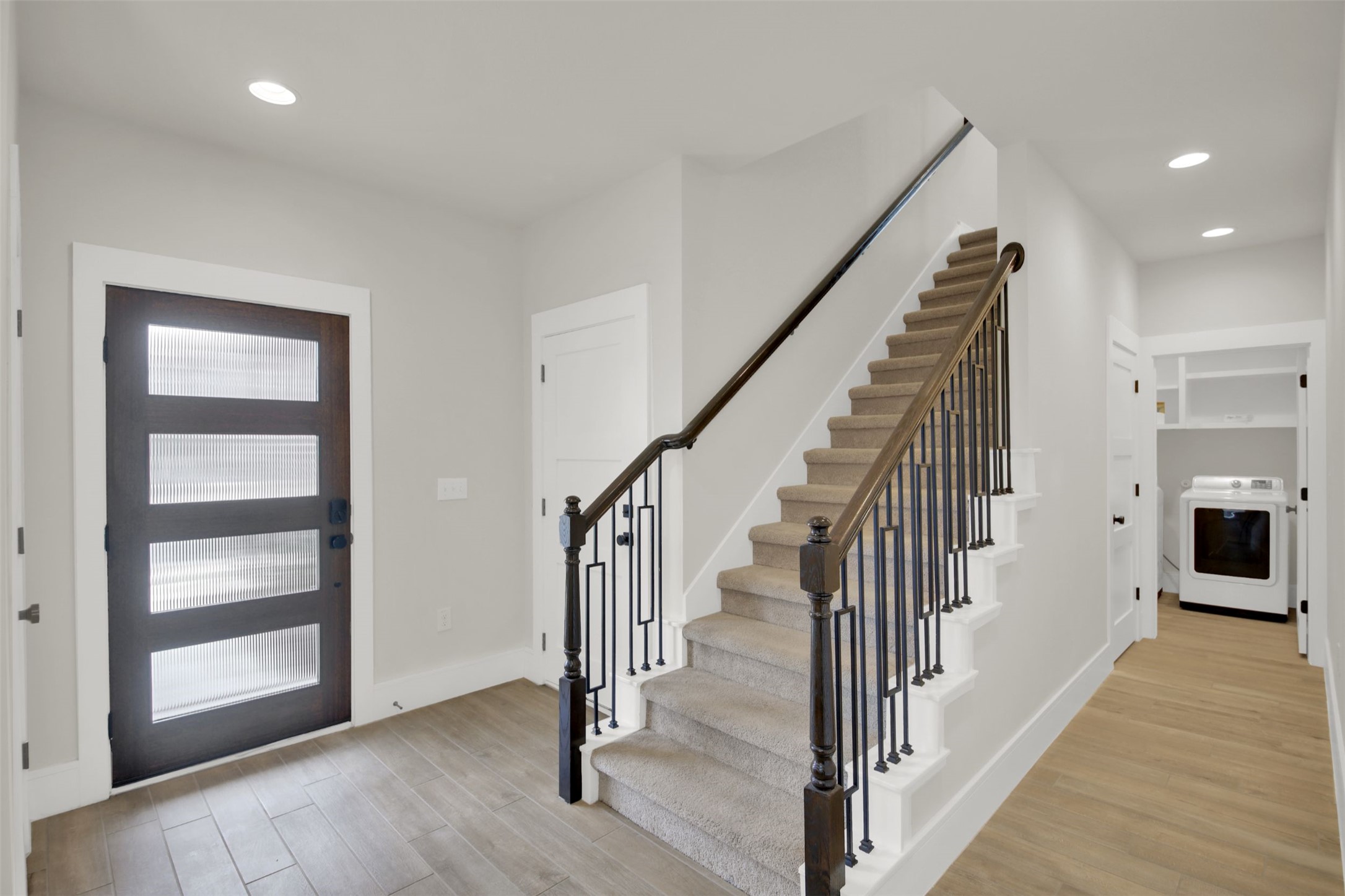964 Pepperbark Loop Buda, TX 78610 - Photo 6 of 35 Entrance foyer featuring washer / clothes dryer, light wood-style flooring, and recessed lighting
