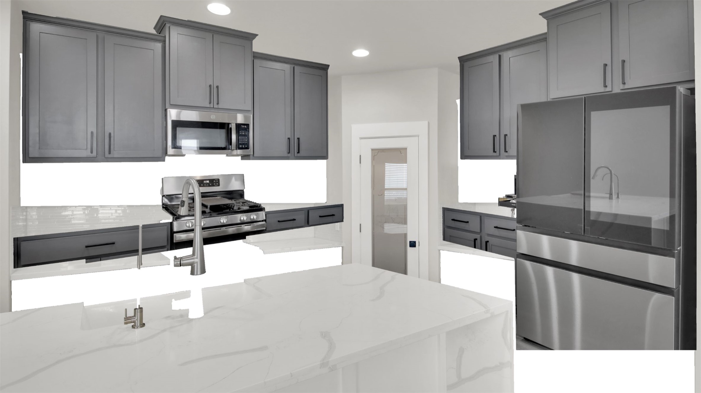 964 Pepperbark Loop Buda, TX 78610 - Photo 8 of 35 Kitchen with stainless steel appliances, light stone countertops, recessed lighting, and gray cabinetry