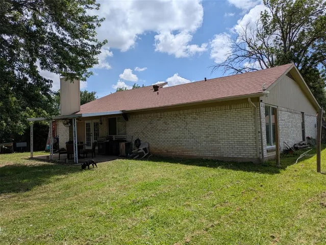 a view of a patio with table and chairs under an umbrella
