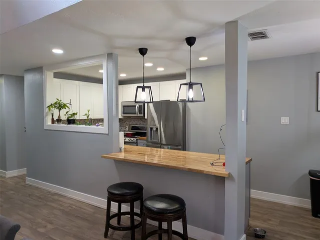 a view of kitchen with cabinets