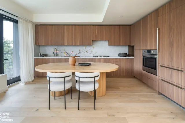 a kitchen with a sink cabinets and window