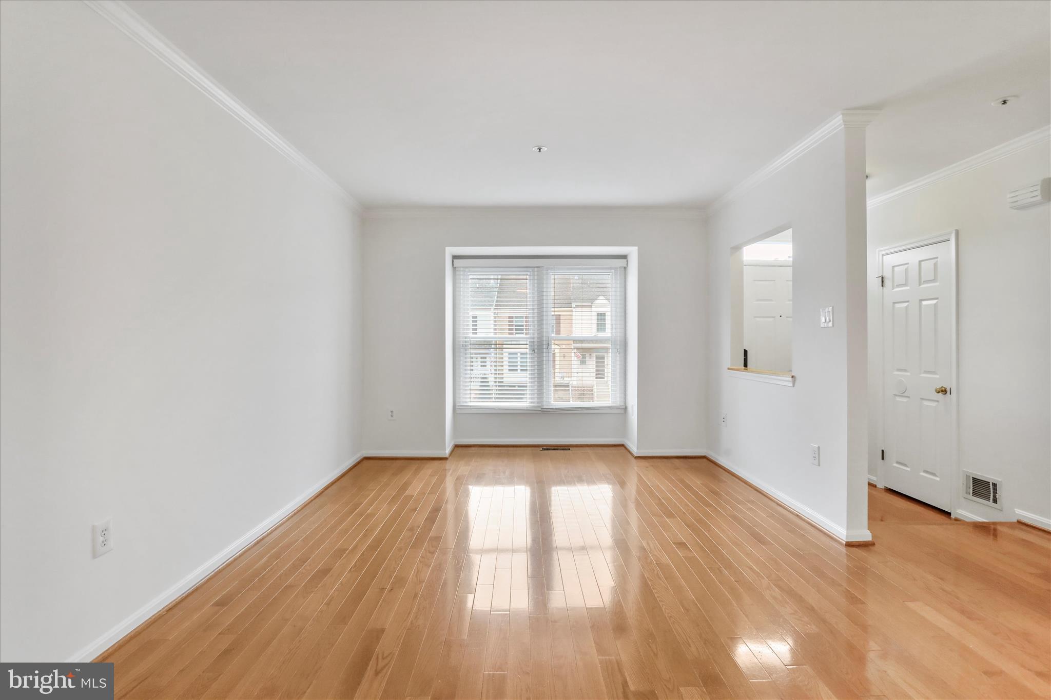 7858 Blue Gray Circle Manassas, VA 20109 - Photo 12 of 38 a view of an empty room with wooden floor and a window