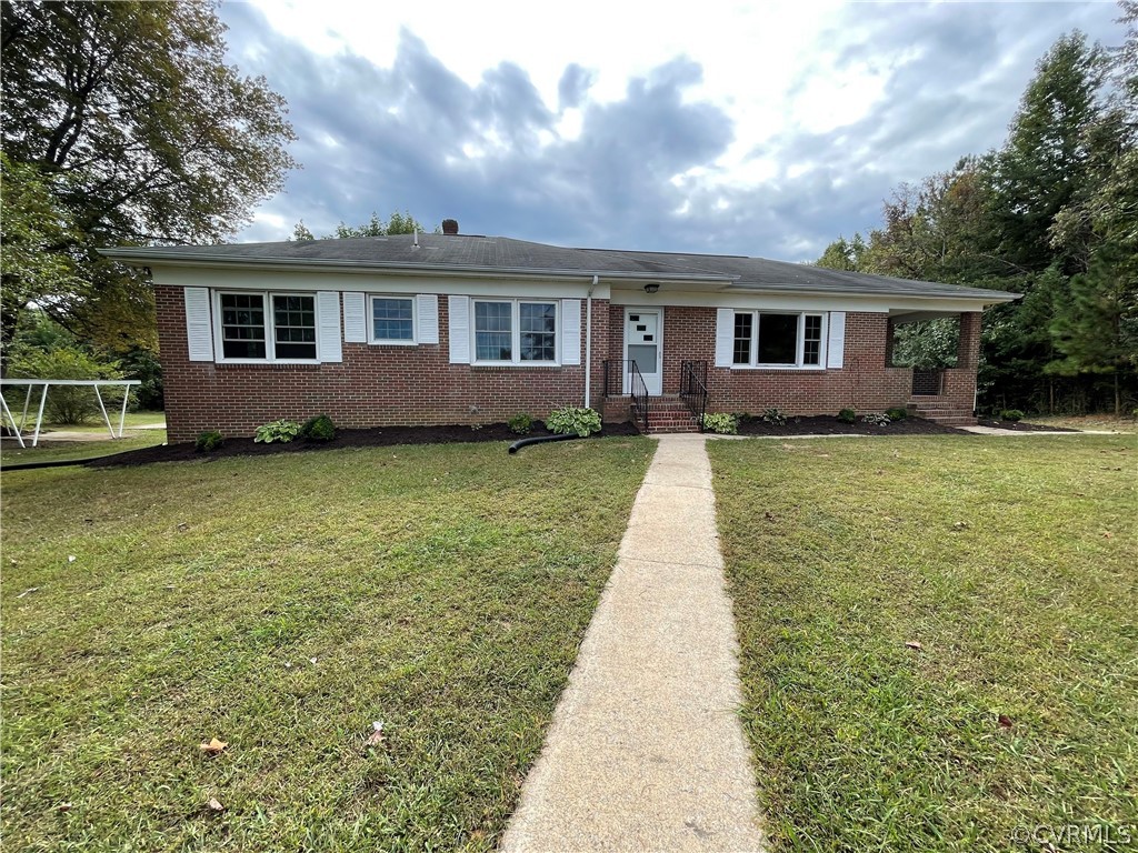 a front view of a house with a garden and yard