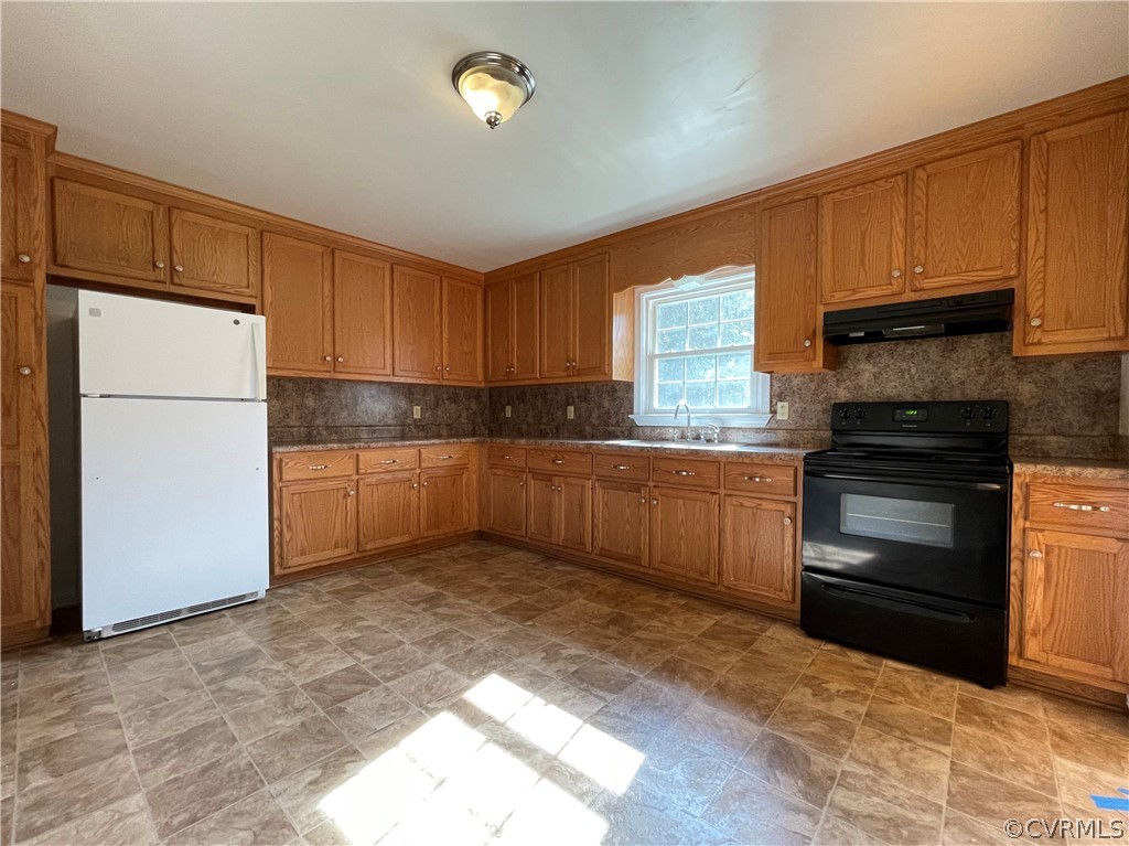 298 John Randolph Road Farmville, VA 23901 - Photo 14 of 50 a kitchen with granite countertop a refrigerator sink and cabinets