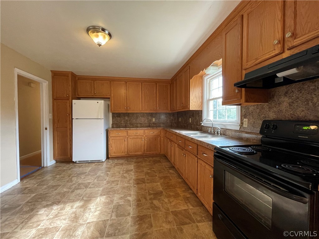 298 John Randolph Road Farmville, VA 23901 - Photo 17 of 50 a kitchen with a refrigerator and a sink