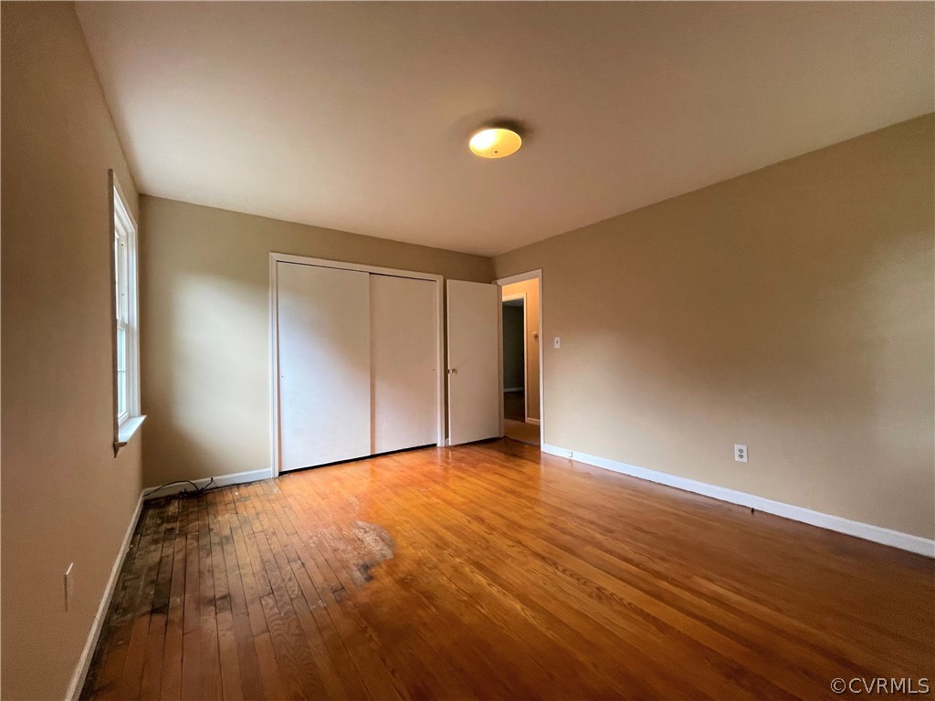 298 John Randolph Road Farmville, VA 23901 - Photo 20 of 50 a view of an empty room with wooden floor and a window