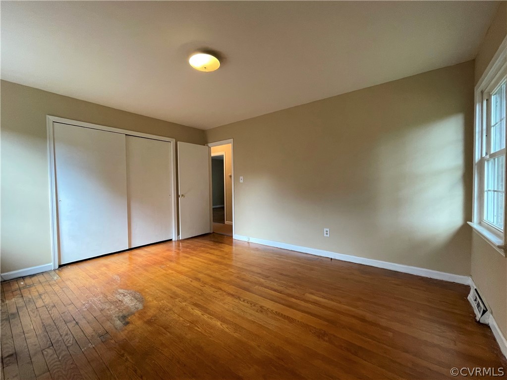 298 John Randolph Road Farmville, VA 23901 - Photo 22 of 50 a view of an empty room with wooden floor and a window