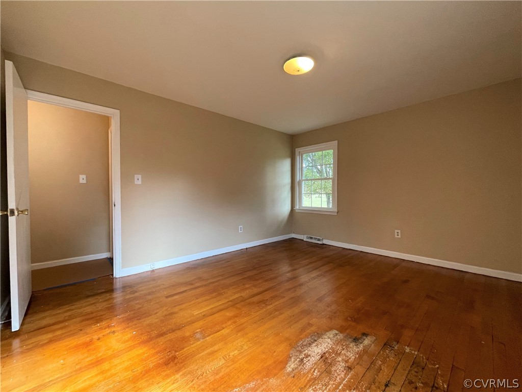 298 John Randolph Road Farmville, VA 23901 - Photo 23 of 50 an empty room with wooden floor and windows