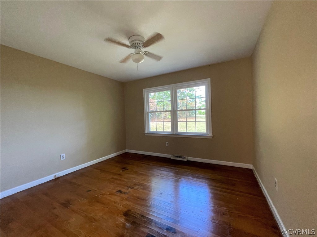 298 John Randolph Road Farmville, VA 23901 - Photo 25 of 50 a view of an empty room with wooden floor and a window