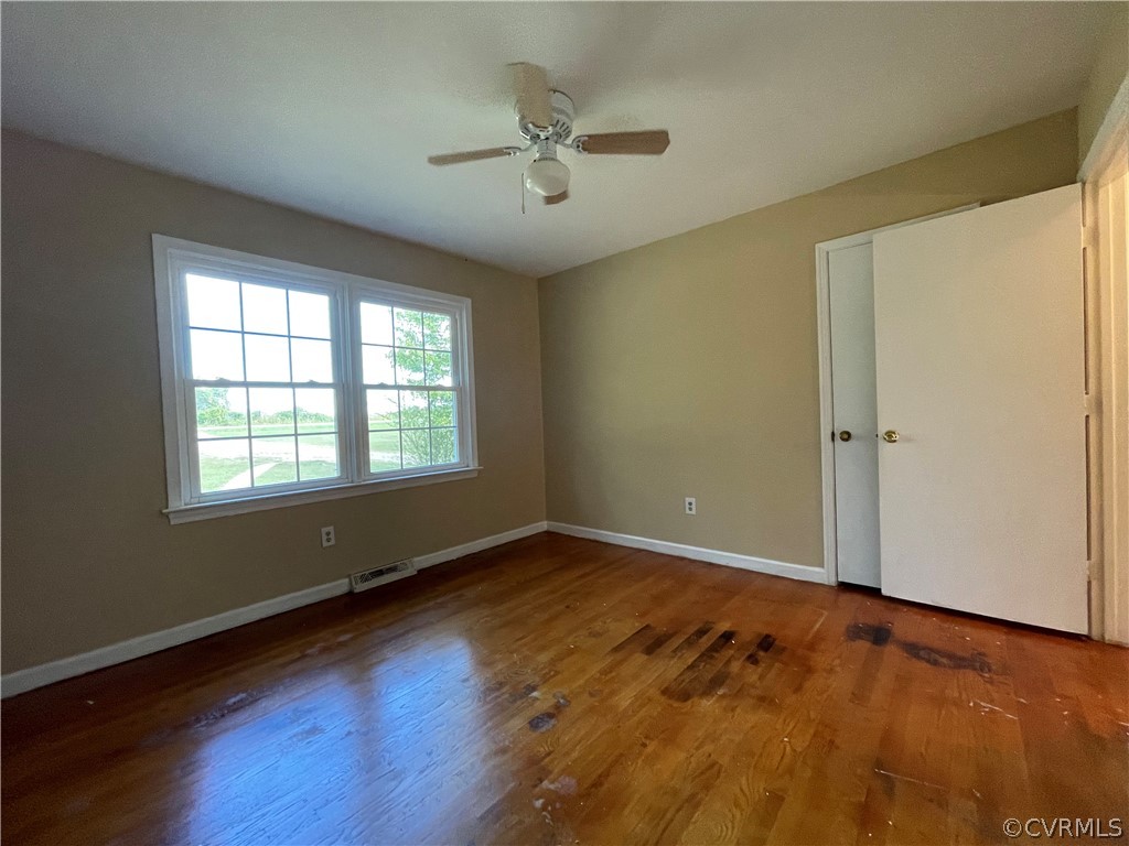 298 John Randolph Road Farmville, VA 23901 - Photo 26 of 50 an empty room with wooden floor and windows