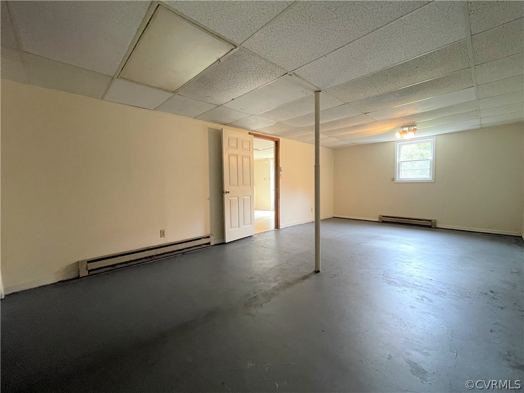 298 John Randolph Road Farmville, VA 23901 - Photo 44 of 50 an empty room with wooden floor and windows with curtains