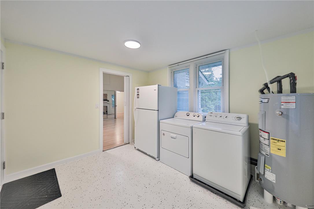 5599 Minks Pond Road Bushkill, PA 18324 - Photo 20 of 64 A well-equipped utility space features essential laundry appliances and durable speckled flooring.